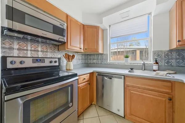 a kitchen with cabinets appliances and a sink