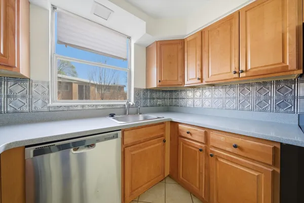a kitchen with stainless steel appliances white cabinets and a sink