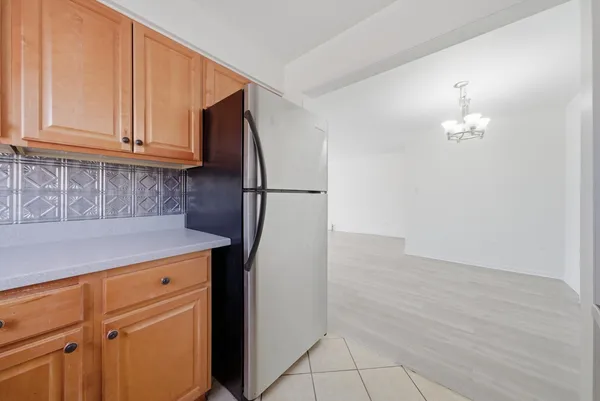 a kitchen with a refrigerator and cabinets