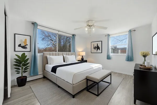 a bedroom with a large bed couch and a window