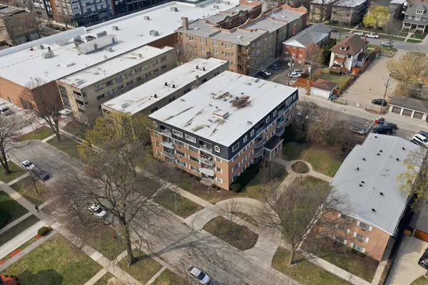 an aerial view of a houses with yard