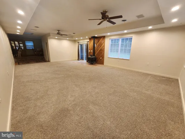 a view of a livingroom with furniture and a ceiling fan