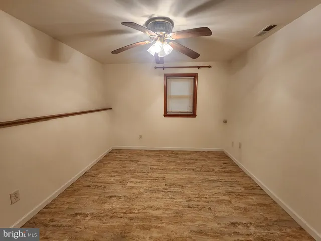 a view of a room with a ceiling fan and a rug