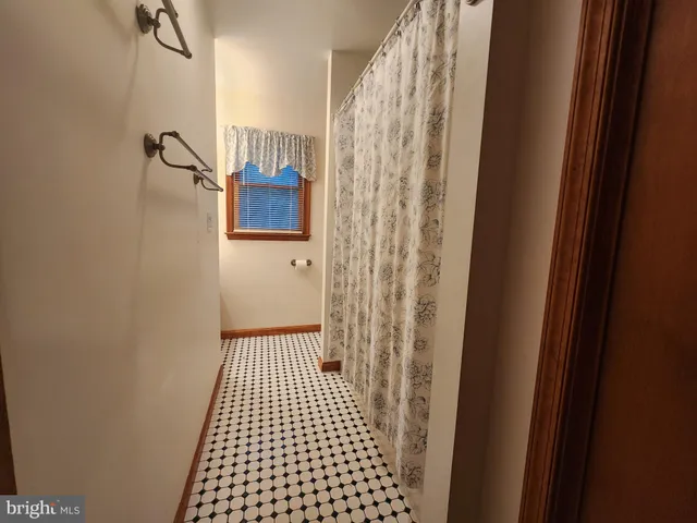 a bathroom with a granite countertop toilet and a mirror