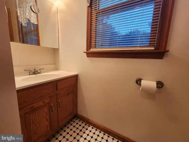 a bathroom with a toilet and a mirror