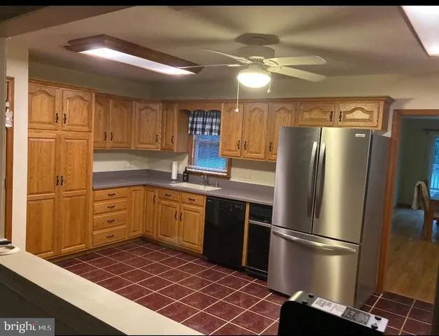 a kitchen with a refrigerator and cabinets