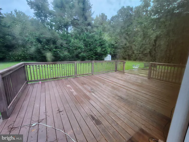 a view of a wooden deck with a yard