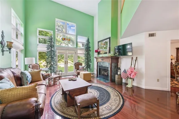 a living room with furniture a rug and a large window