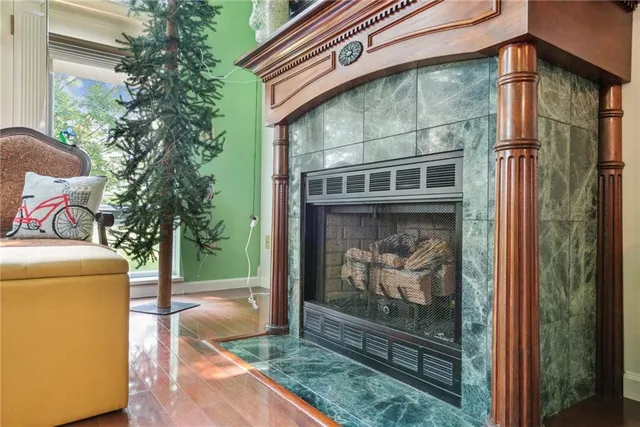 a blue couch sitting in a living room next to a window