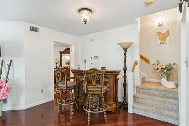a living room with furniture and wall paintings