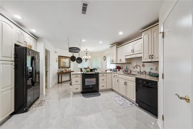 a kitchen with stainless steel appliances a stove refrigerator sink and microwave