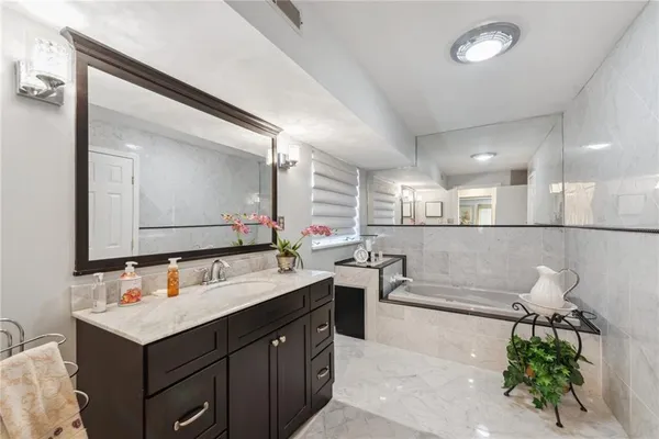 a bathroom with a tub and shower