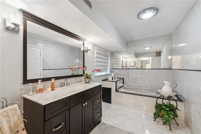 a bathroom with a tub and shower