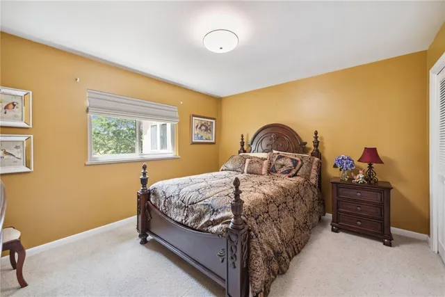 a bedroom with a bed and a dresser in it