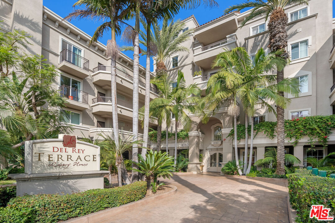 4060 Glencoe Avenue, Unit 228 Marina del Rey, CA 90292 - Photo 1 of 18 a front view of a multi story residential apartment building with yard and parking