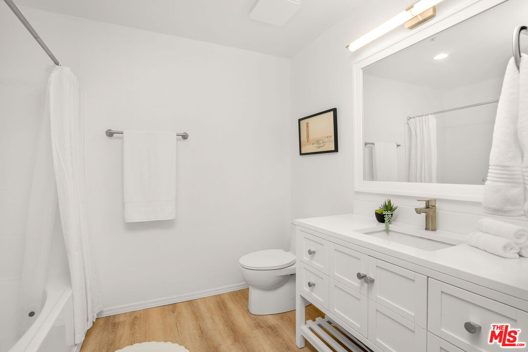 4060 Glencoe Avenue, Unit 228 Marina del Rey, CA 90292 - Photo 11 of 18 a bathroom with a sink toilet and vanity