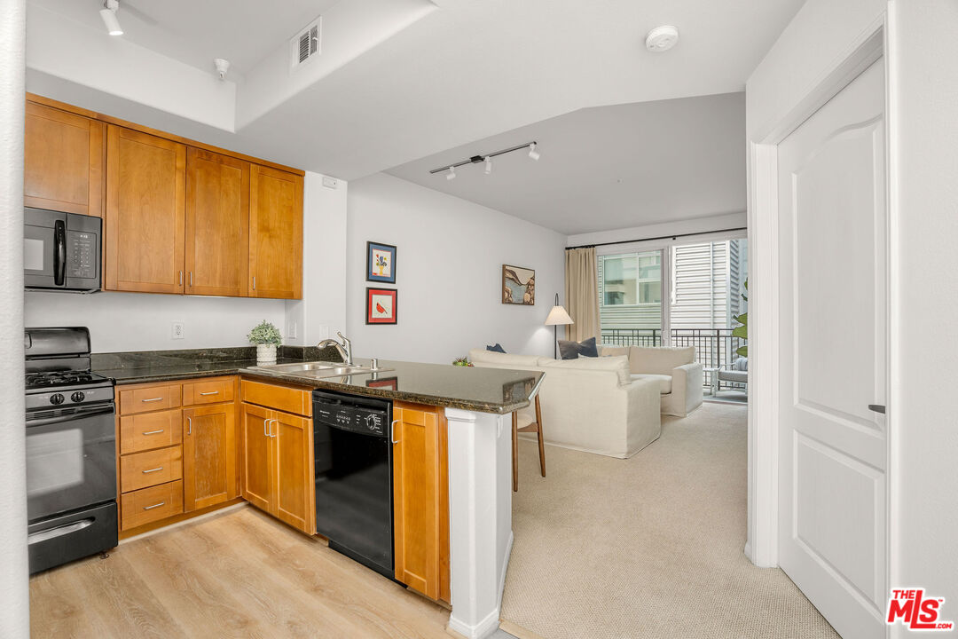 4060 Glencoe Avenue, Unit 228 Marina del Rey, CA 90292 - Photo 2 of 18 a kitchen with cabinets a sink and appliances