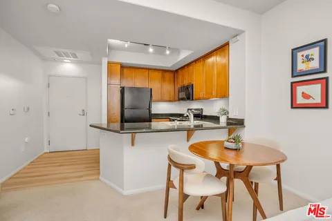 a kitchen with a table chairs sink and microwave