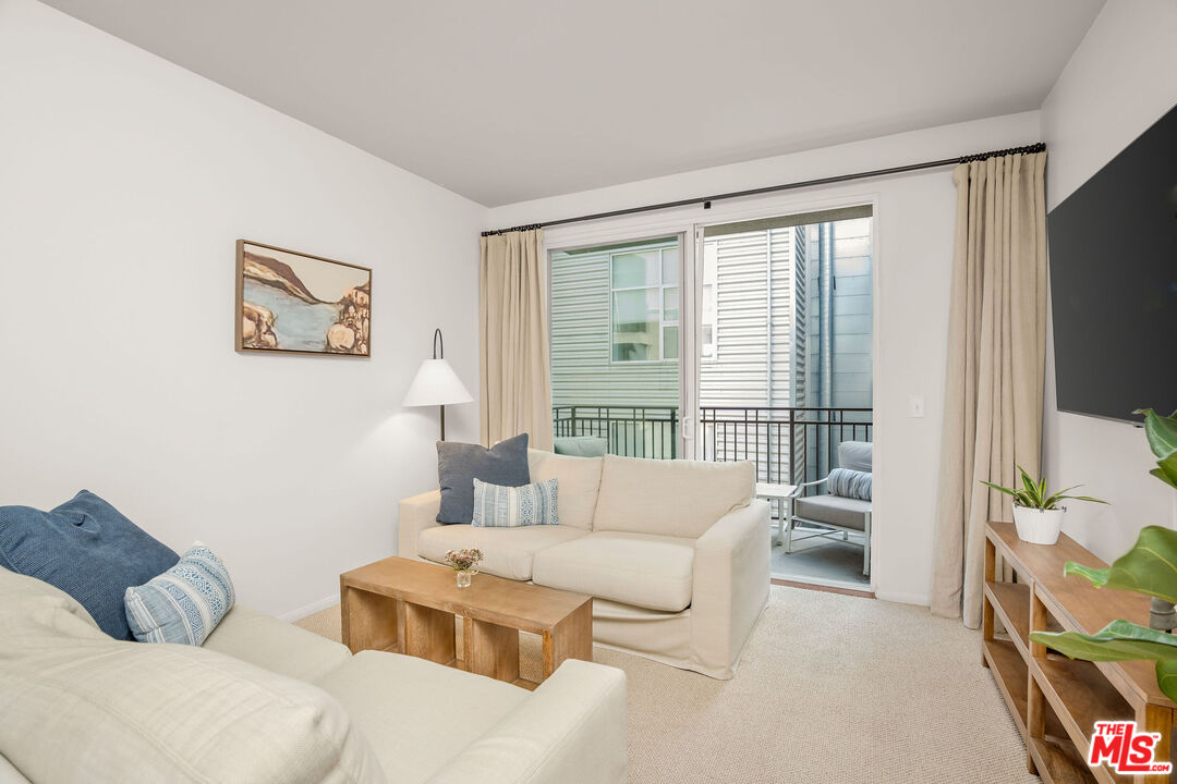 4060 Glencoe Avenue, Unit 228 Marina del Rey, CA 90292 - Photo 5 of 18 a living room with furniture and a large window