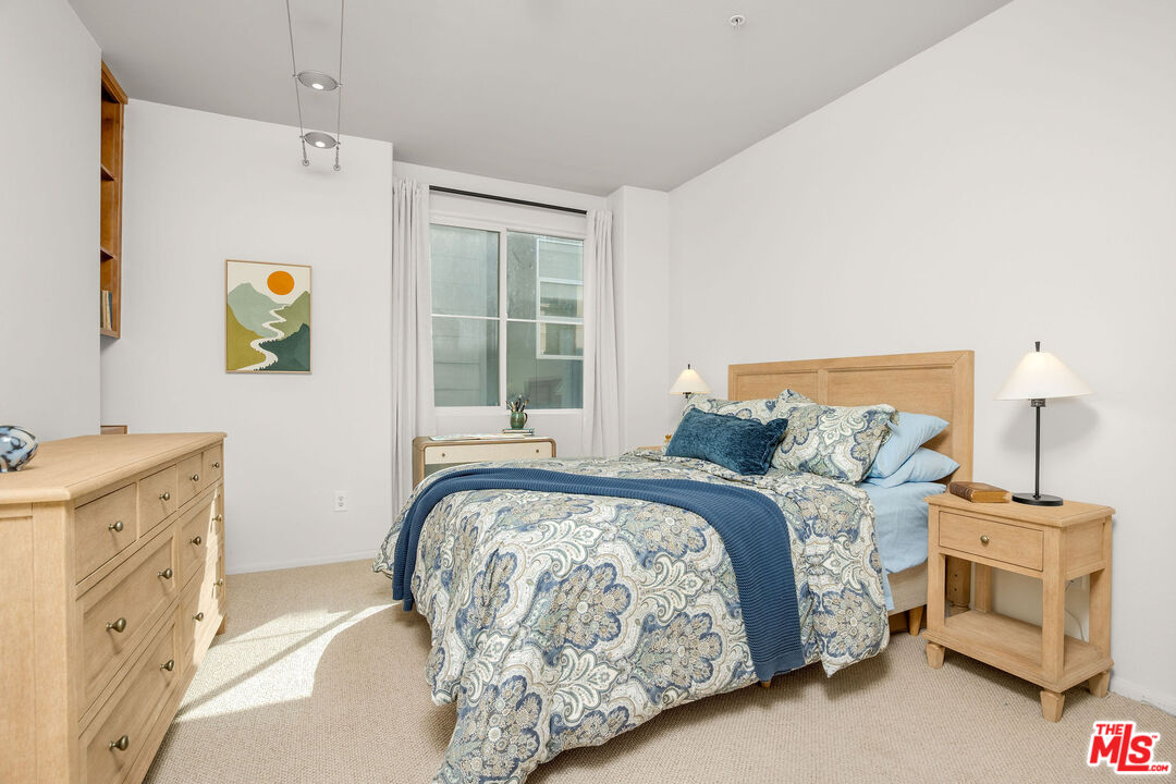 4060 Glencoe Avenue, Unit 228 Marina del Rey, CA 90292 - Photo 8 of 18 a bedroom with a bed and a window