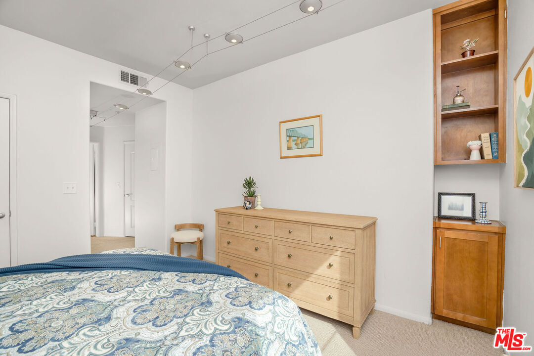 4060 Glencoe Avenue, Unit 228 Marina del Rey, CA 90292 - Photo 9 of 18 a bedroom with a bed and wooden floor