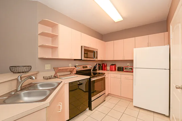 a kitchen with a sink a stove and refrigerator
