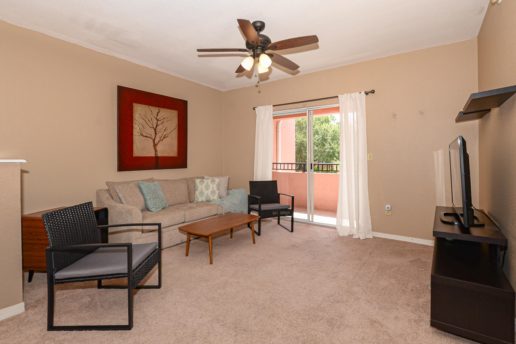 106 Southwest Peacock Boulevard, Unit 4204 Port St. Lucie, FL 34986 - Photo 17 of 46 a living room with furniture a window and a chandelier