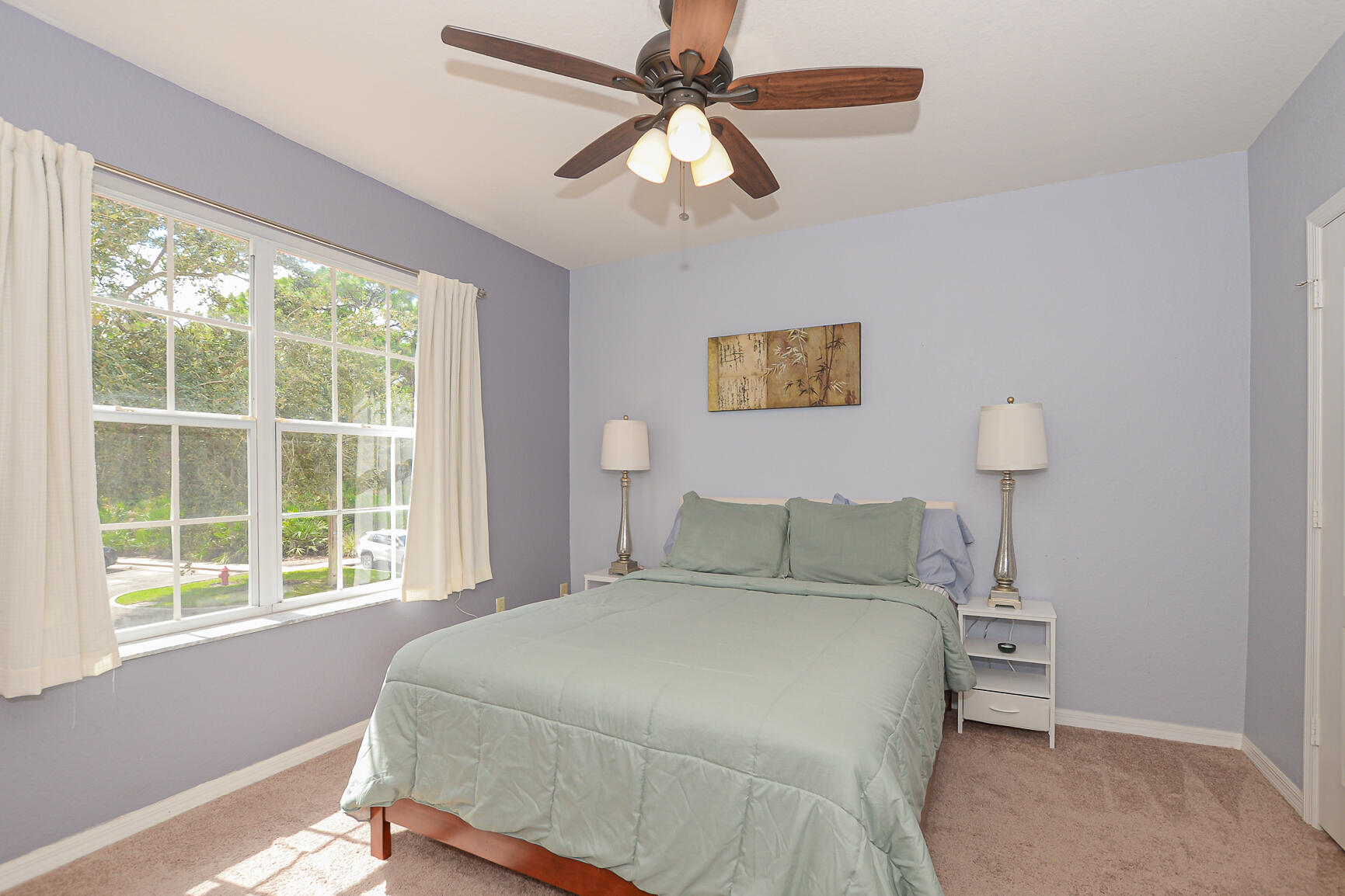 106 Southwest Peacock Boulevard, Unit 4204 Port St. Lucie, FL 34986 - Photo 21 of 46 a bedroom with a bed and a window