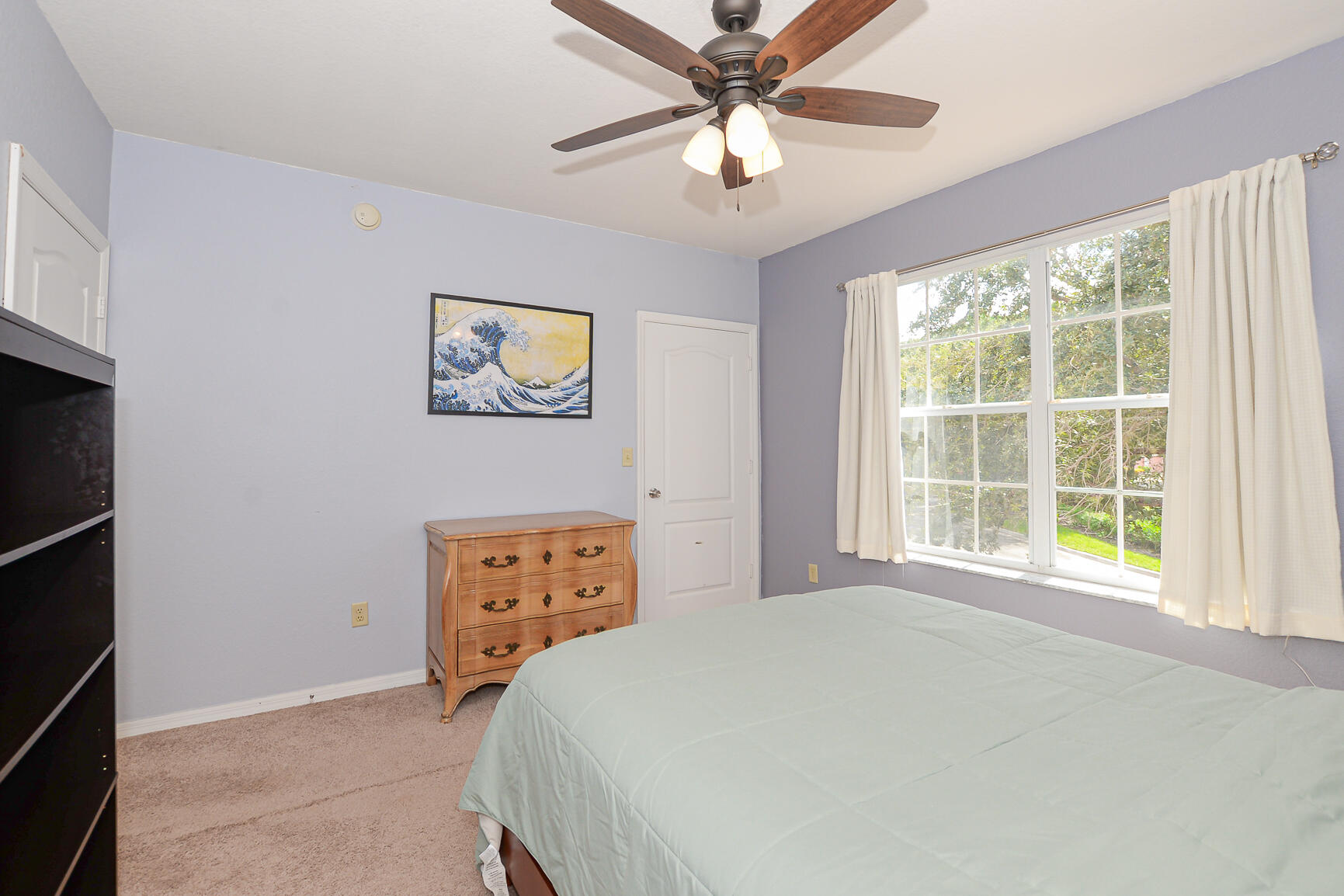 106 Southwest Peacock Boulevard, Unit 4204 Port St. Lucie, FL 34986 - Photo 22 of 46 a bedroom with a bed and a window