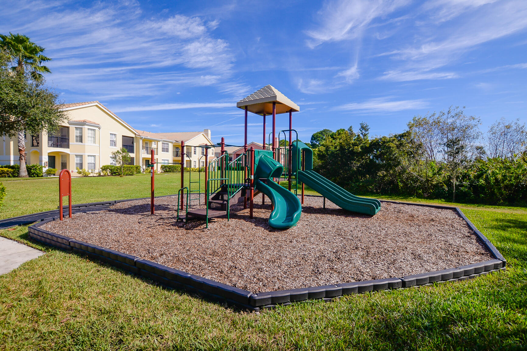 106 Southwest Peacock Boulevard, Unit 4204 Port St. Lucie, FL 34986 - Photo 35 of 46 a park view with a sitting space and garden