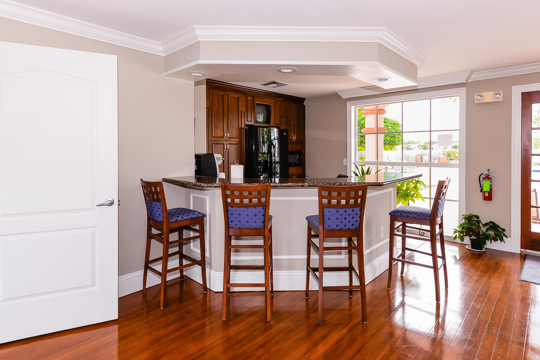 106 Southwest Peacock Boulevard, Unit 4204 Port St. Lucie, FL 34986 - Photo 36 of 46 a dining room with furniture and wooden floor