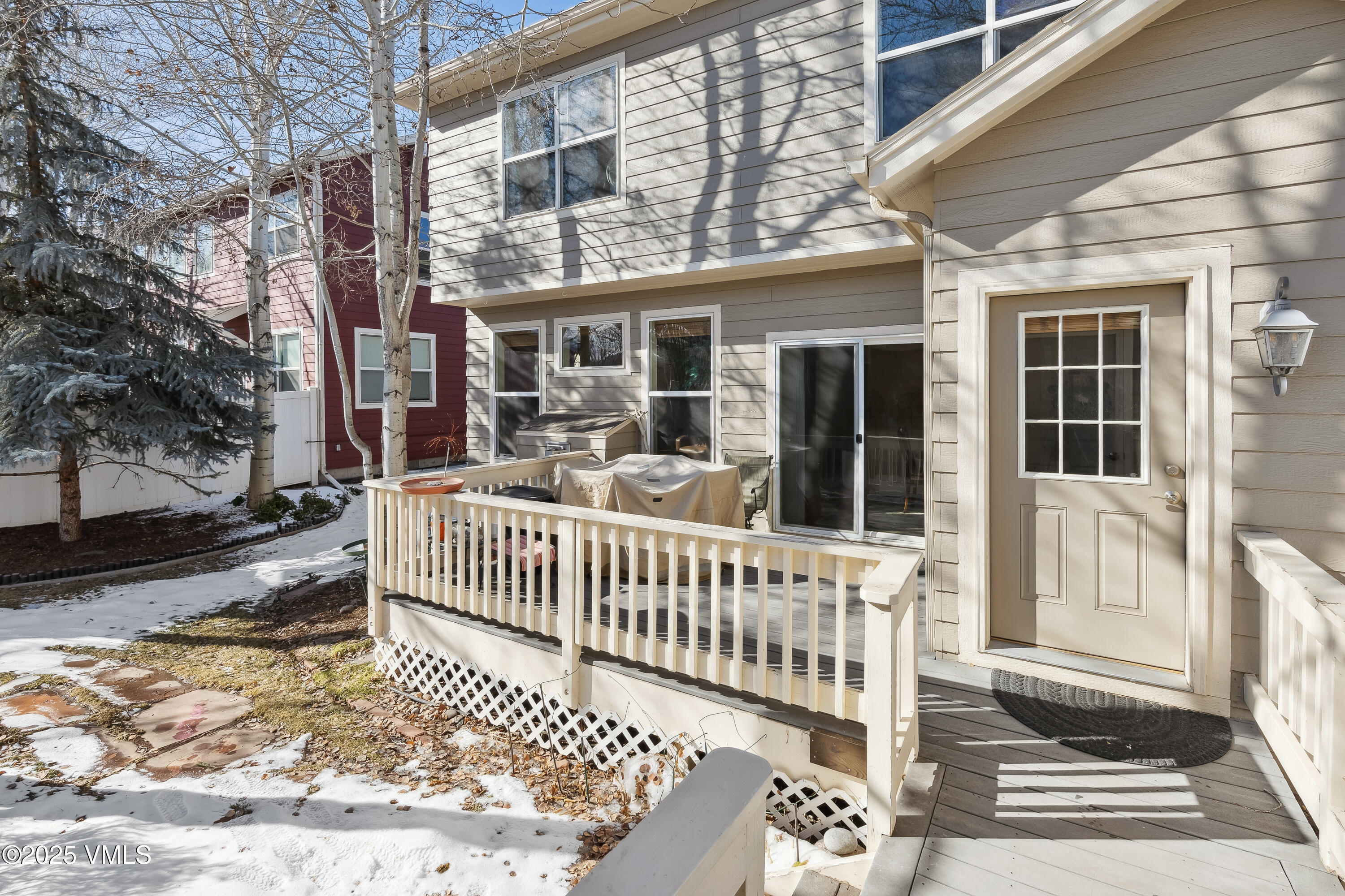 206 Mayer Street Eagle, CO 81631 - Photo 36 of 38 a porch with a bench next to a yard