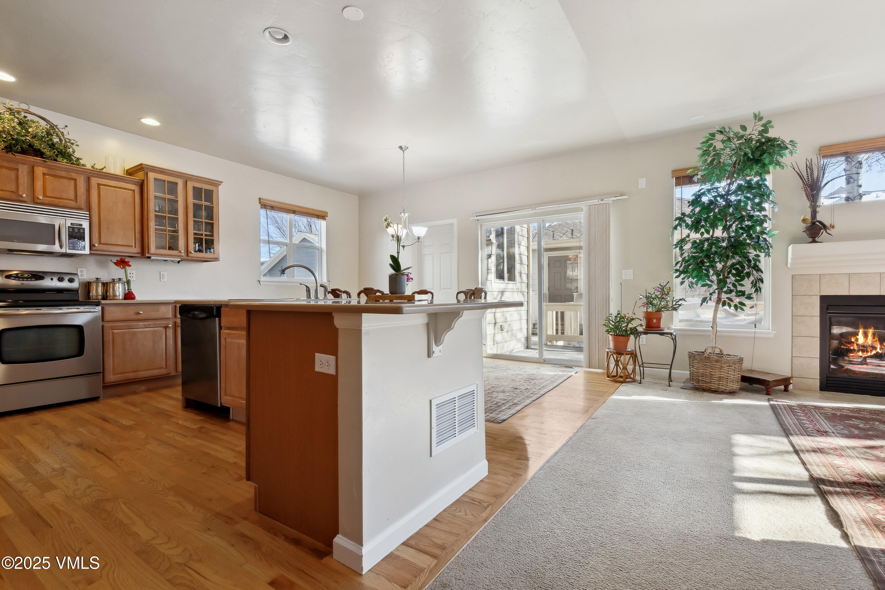 206 Mayer Street Eagle, CO 81631 - Photo 5 of 38 a view of a kitchen with kitchen island a stove a sink a refrigerator and a dining table