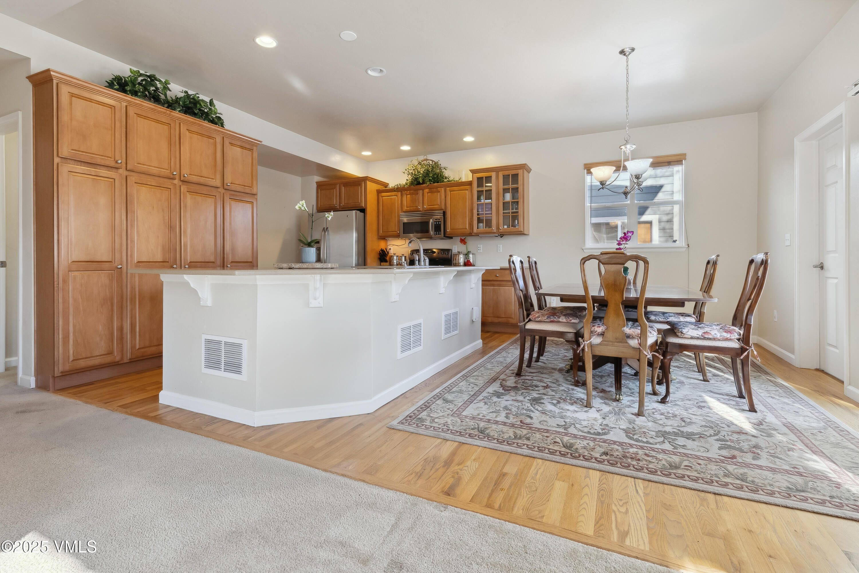 206 Mayer Street Eagle, CO 81631 - Photo 6 of 38 a living room with furniture and a dining table with kitchen view