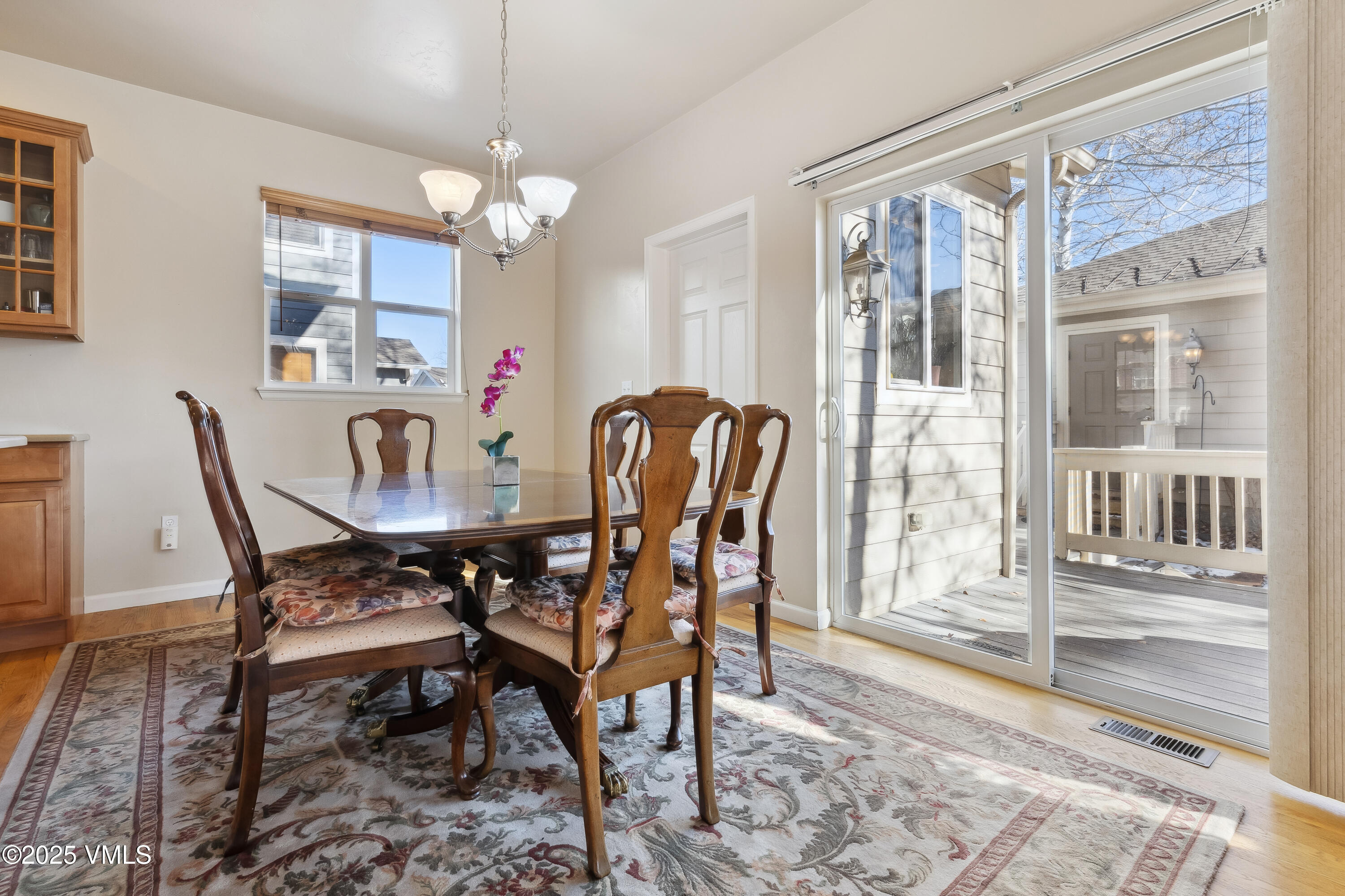 206 Mayer Street Eagle, CO 81631 - Photo 7 of 38 a dining room with furniture a chandelier and wooden floor