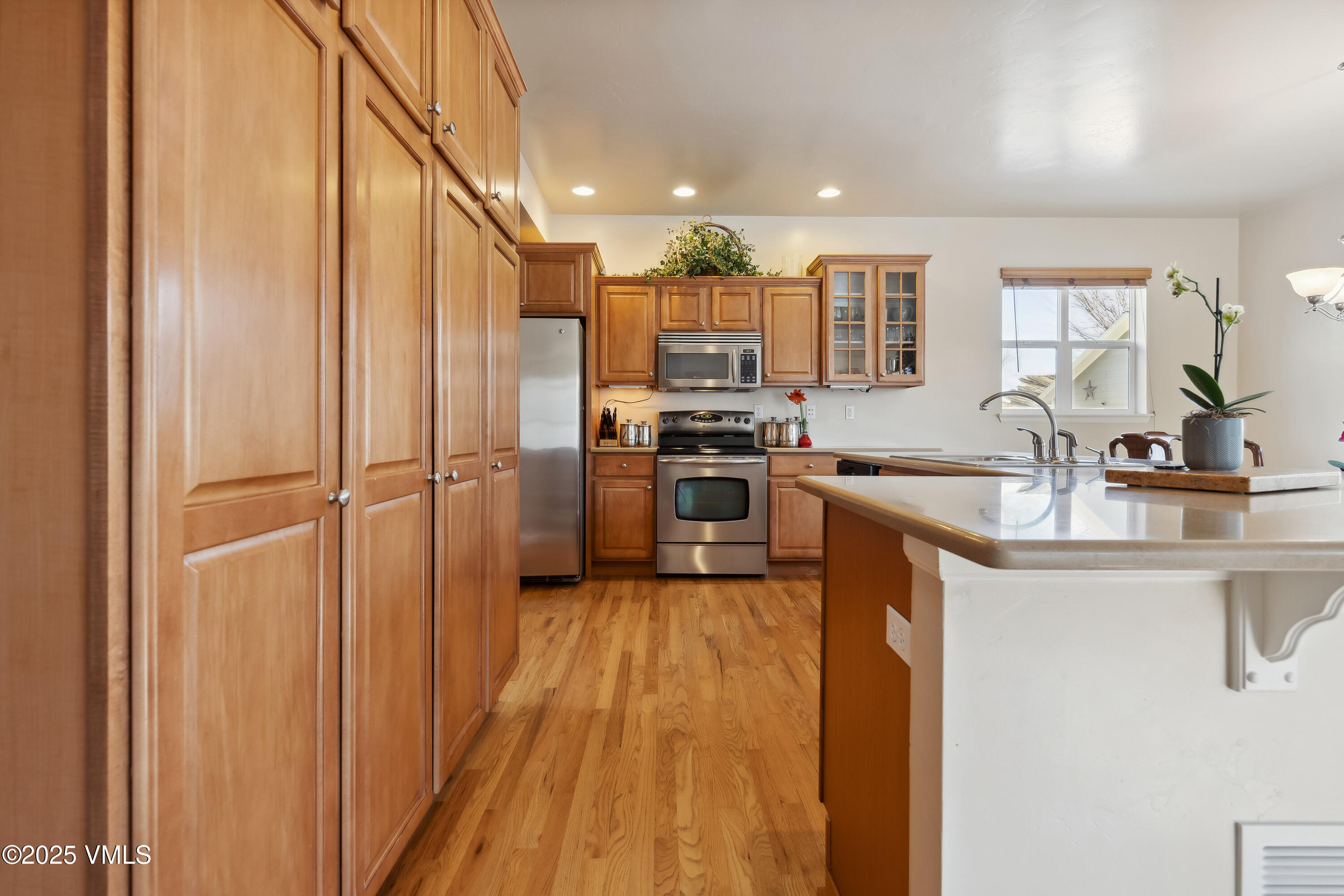 206 Mayer Street Eagle, CO 81631 - Photo 8 of 38 a kitchen with stainless steel appliances granite countertop a sink stove and refrigerator