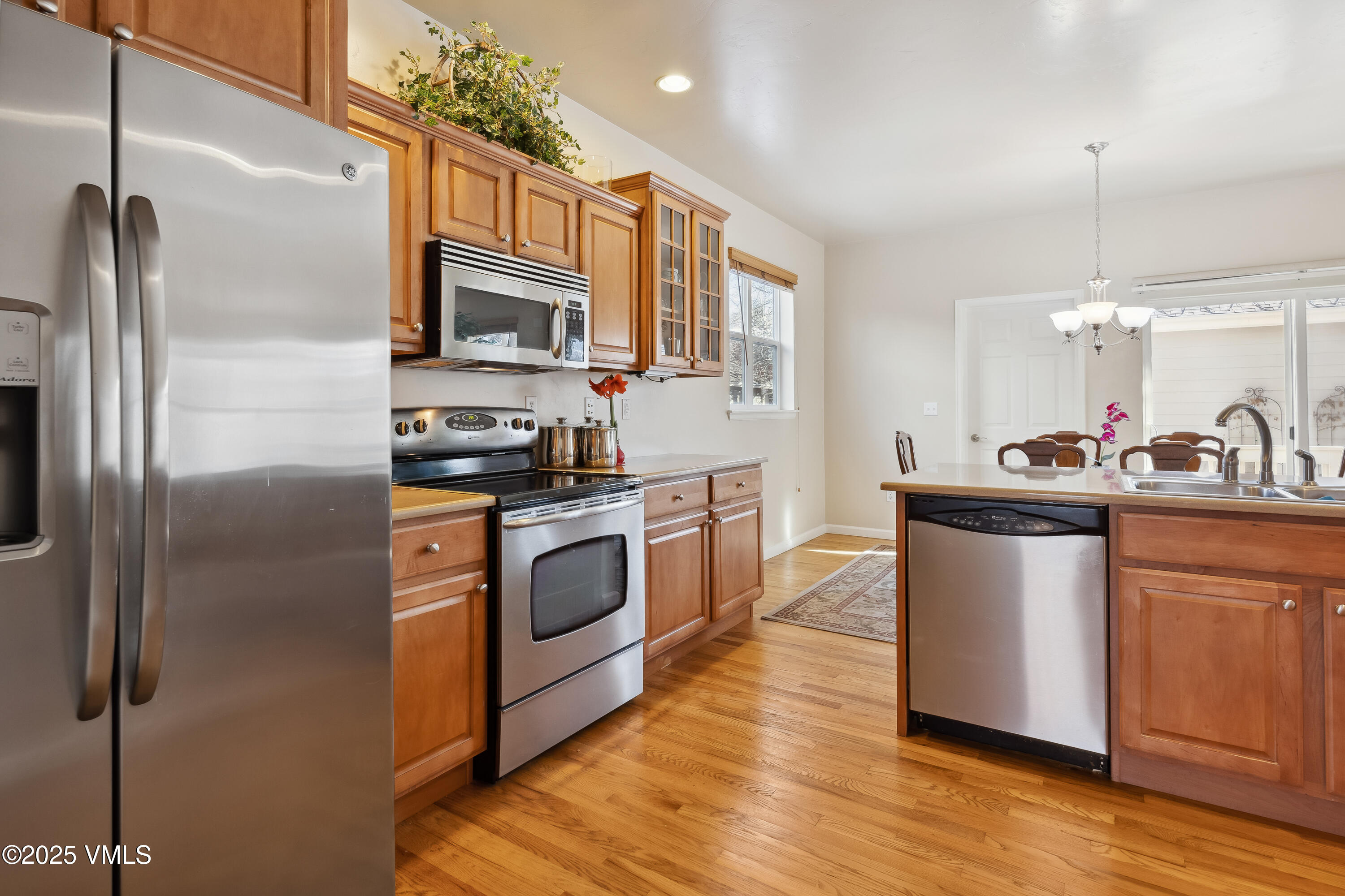 206 Mayer Street Eagle, CO 81631 - Photo 10 of 38 a kitchen with stainless steel appliances granite countertop a refrigerator a stove a sink and a microwave