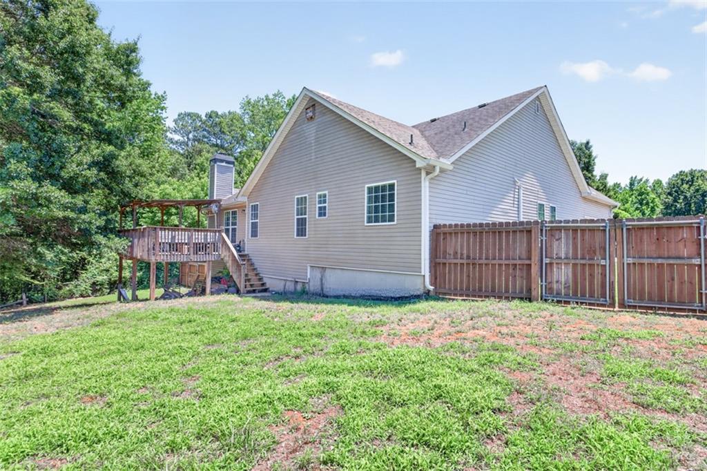 89 Katie Spring Lane Jefferson, GA 30549 - Photo 56 of 63 a view of a house with a yard and fence