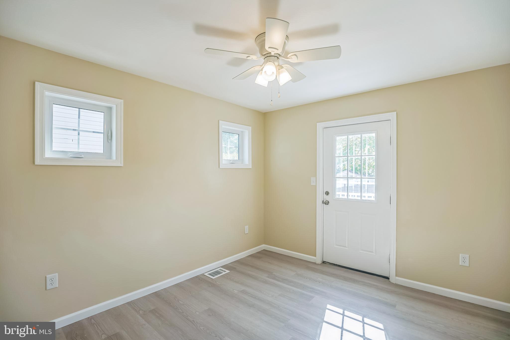 208 Hooker Street Riverside, NJ 08075 - Photo 11 of 25 an empty room with windows and fan