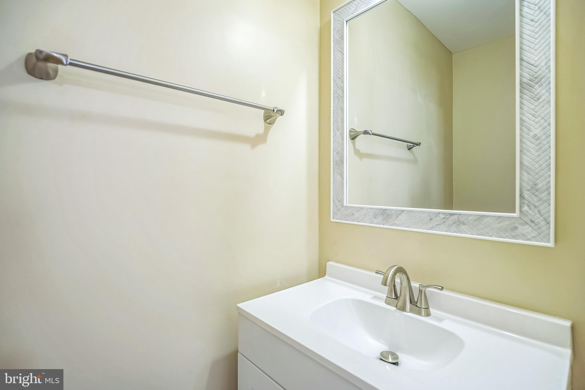 208 Hooker Street Riverside, NJ 08075 - Photo 12 of 25 a bathroom with a sink and a mirror