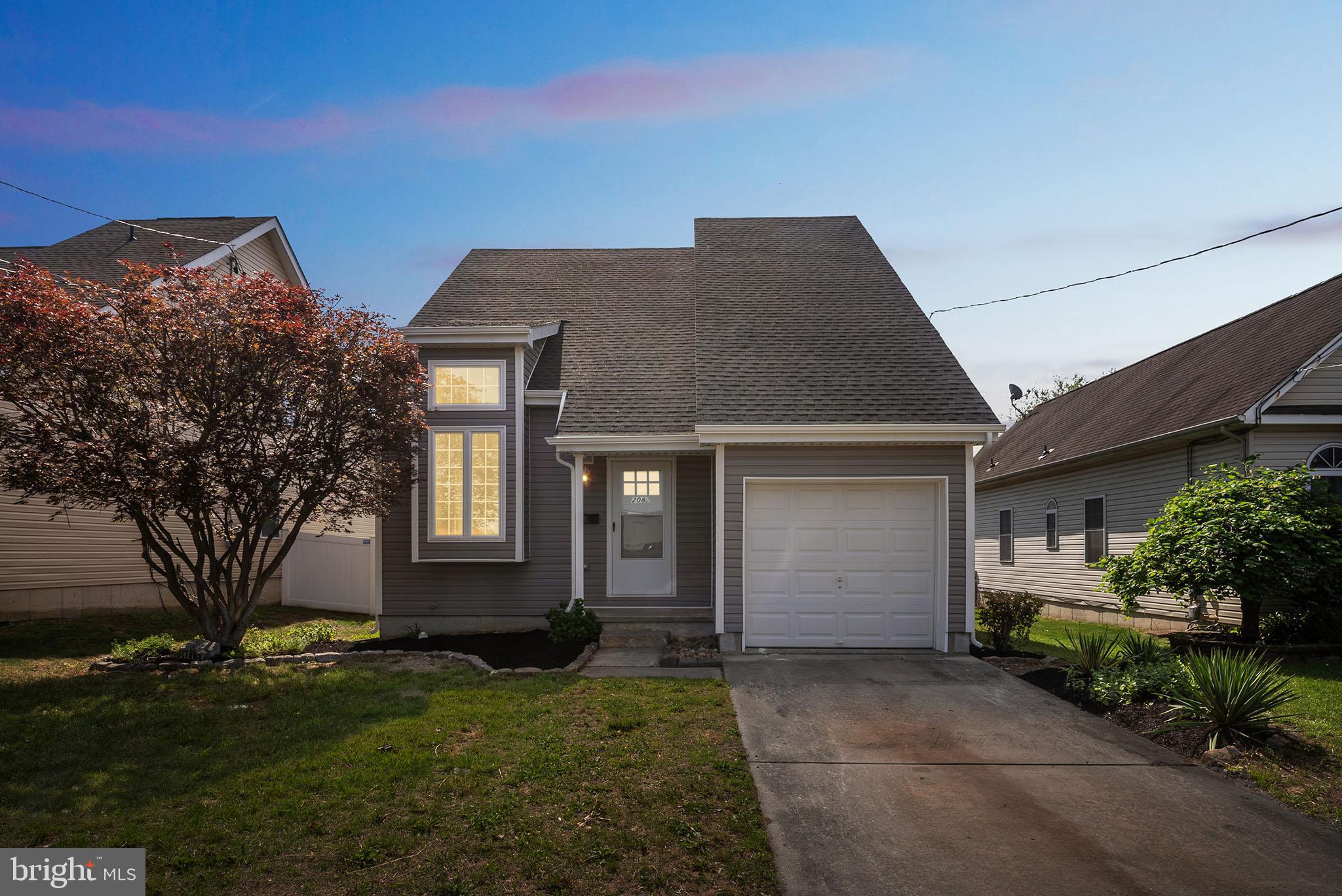 208 Hooker Street Riverside, NJ 08075 - Photo 2 of 25 a front view of a house with a yard and garage