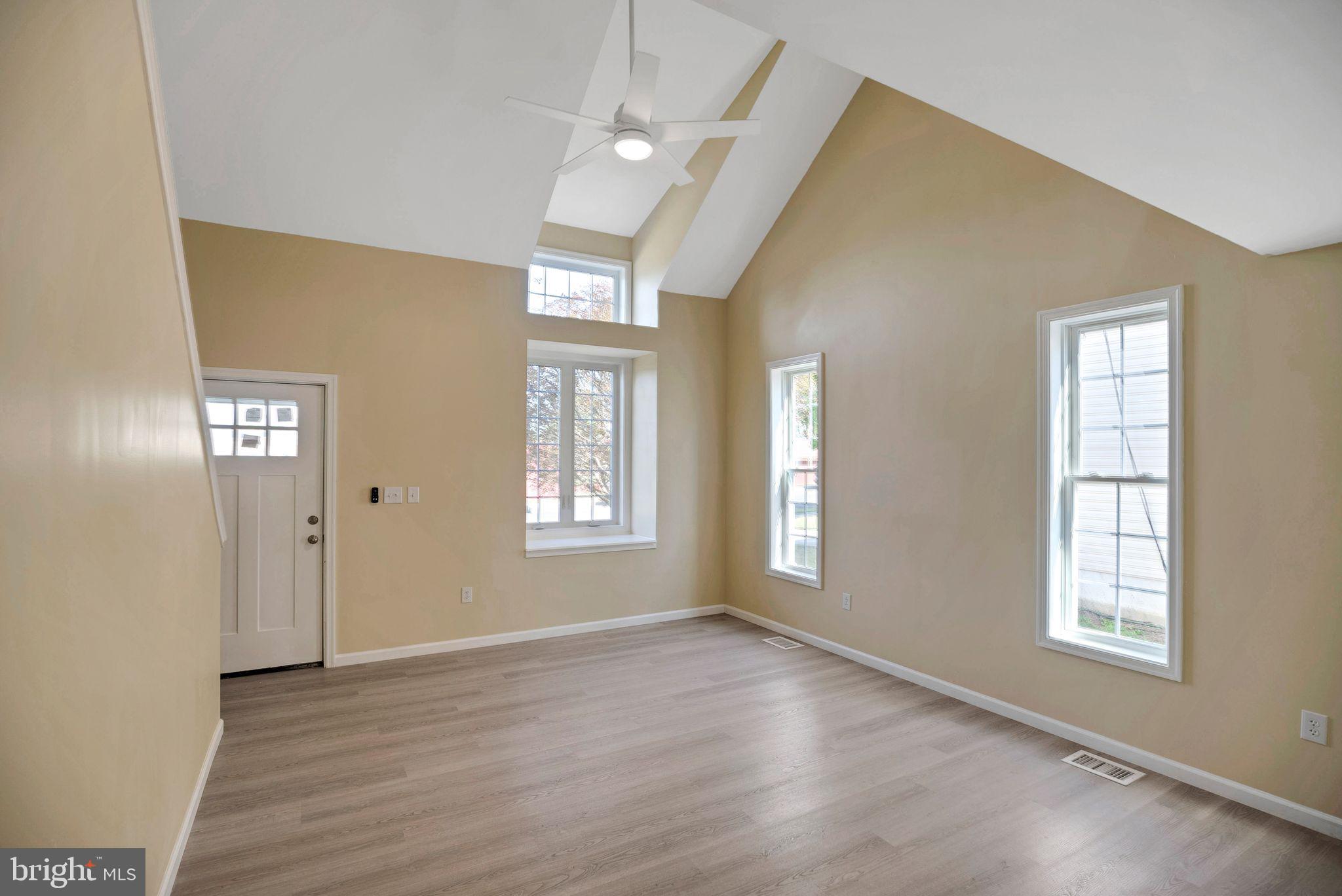 208 Hooker Street Riverside, NJ 08075 - Photo 3 of 25 a view of an empty room with wooden floor and a window