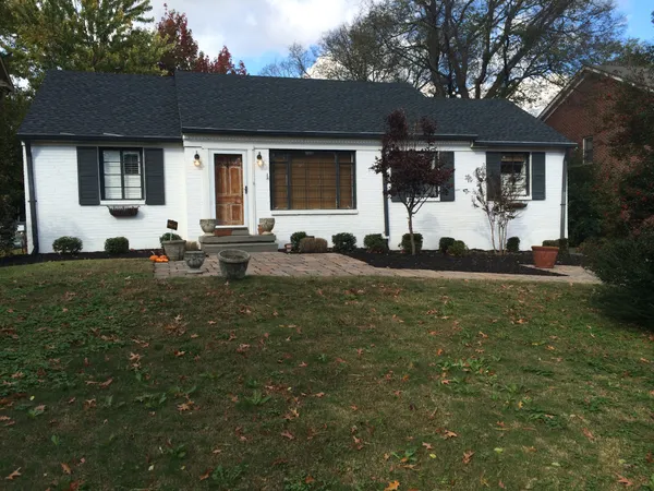 a front view of house with yard outdoor seating and green space