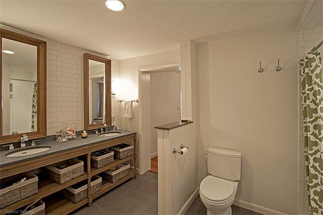 1714 Glen Echo Road Nashville, TN 37215 - Photo 4 of 12 a bathroom with a sink a toilet a mirror and shower