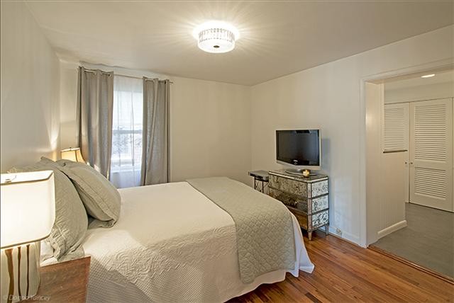 1714 Glen Echo Road Nashville, TN 37215 - Photo 7 of 12 a bedroom with a bed a flat screen tv and a window