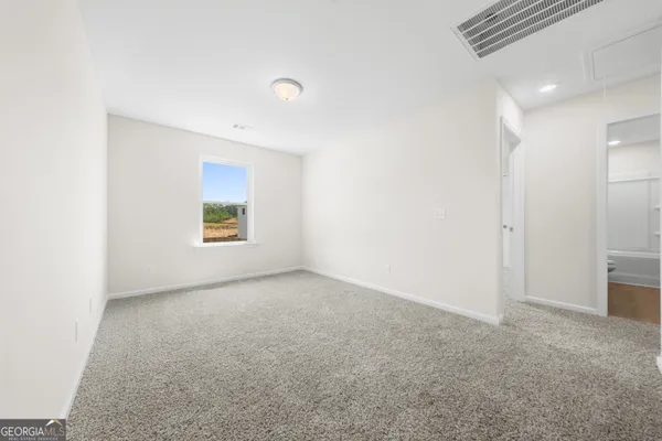 a view of an empty room and a window