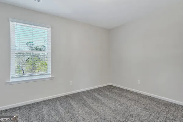 a view of an empty room and a window