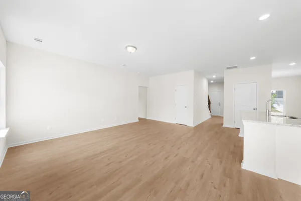 a view of kitchen and empty room