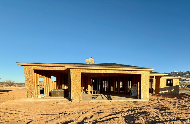 4944 North 925 East, Unit 88 Enoch, UT 84721 - Photo 1 of 9 Back of house with a chimney, a patio area, and board and batten siding