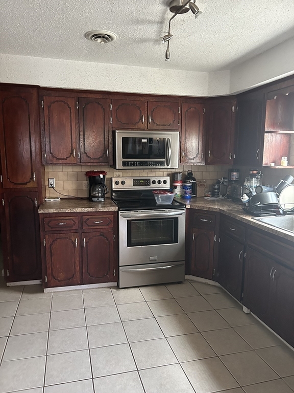 343 Ludlow Street Fall River, MA 02721 - Photo 3 of 14 a kitchen with a sink a stove and cabinets